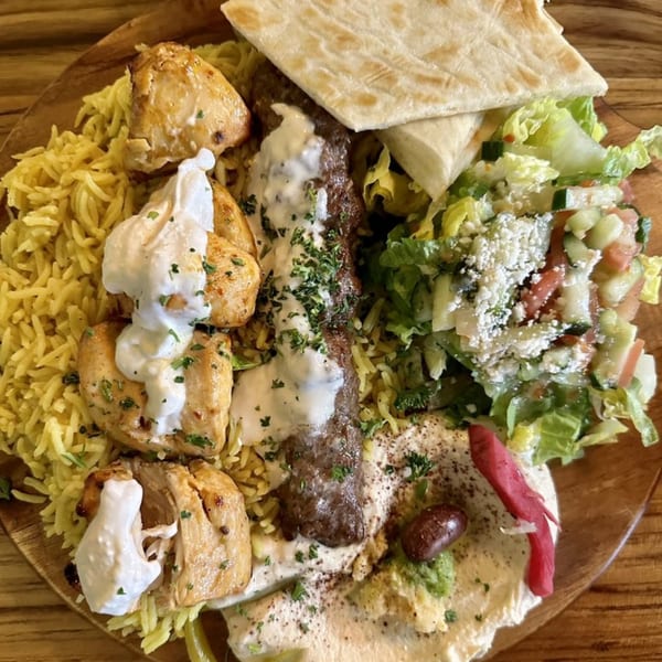 Shawarma Time's Mediterranean platter with chicken, beef, rice, salad, hummus, and pita bread.